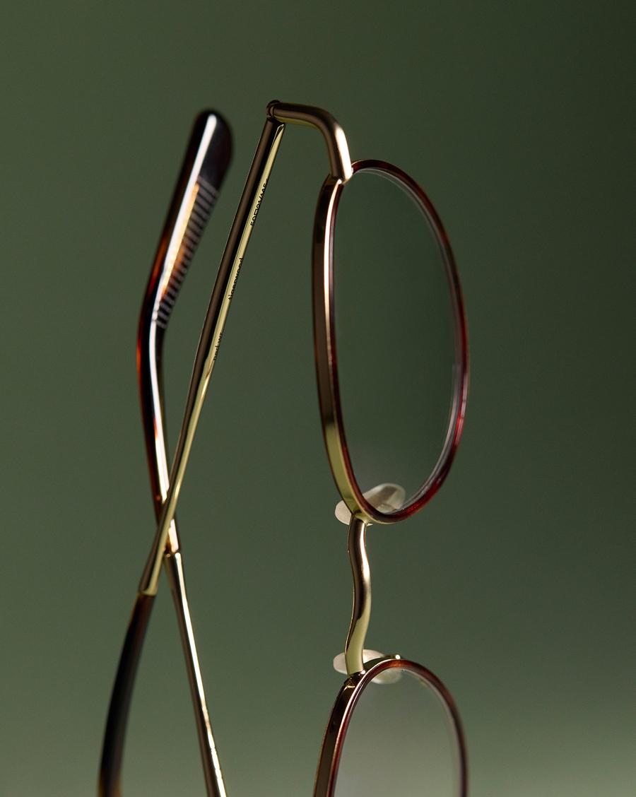 glasses in green background Materials LP