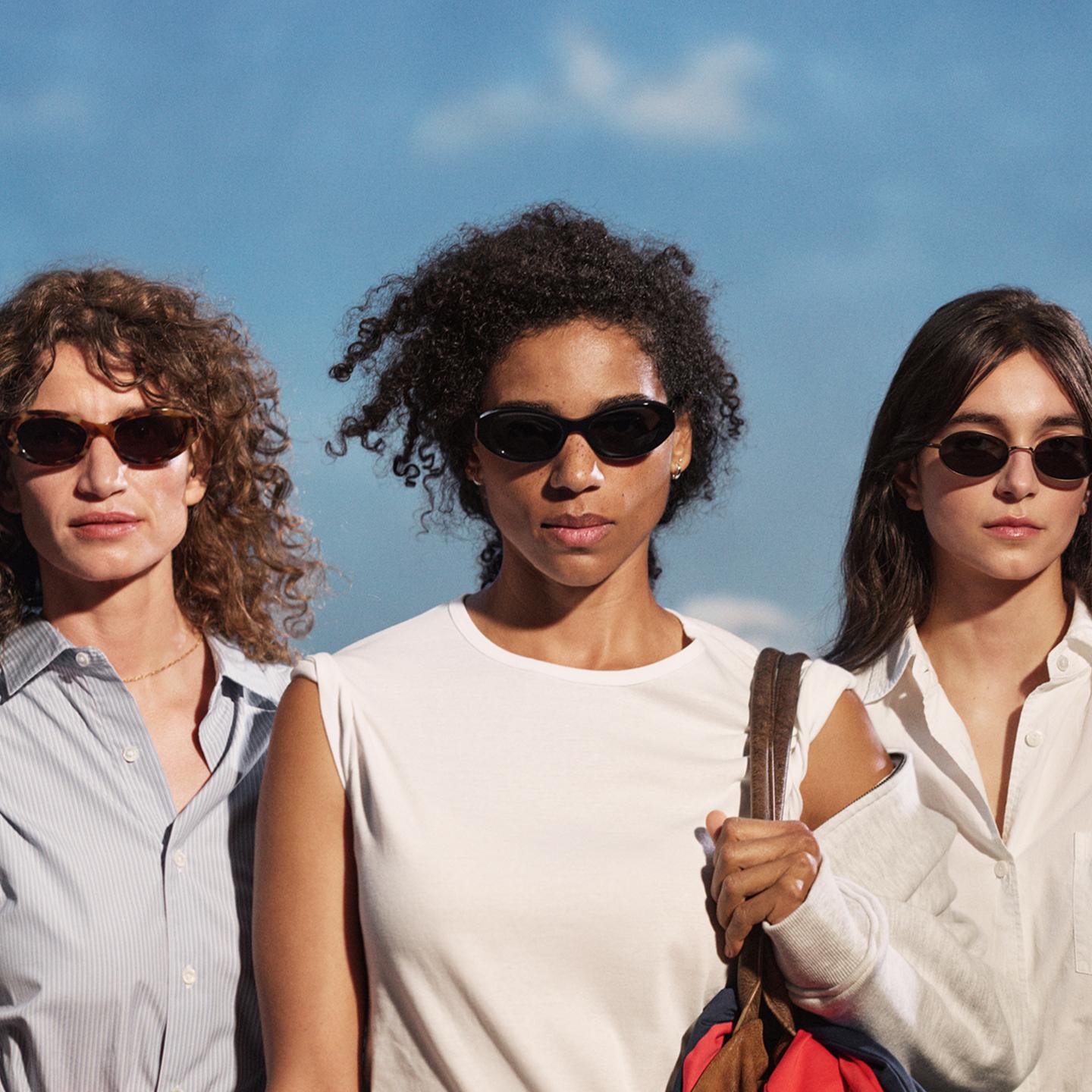 MKT Three females in sunglasses desk
